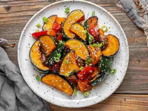 Vegan Chinese Kabocha Squash Recipes: A beautifully plated vegan dish featuring Kabocha squash and stir-fried vegetables, garnished with sesame seeds