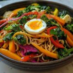 Steaming bowl of noodle mag with vegetables and egg