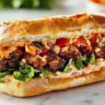 Mouthwatering knob sandwich with overflowing and colorful fillings.