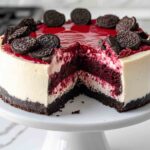 Decadent Red Velvet Oreo Cheesecake with Whipped Cream and Oreo Crumbs